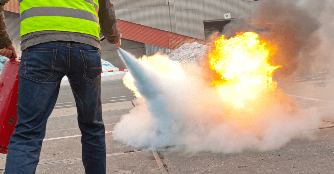 Man using a fire extinguisher 